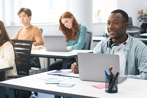 college student at desk with laptop