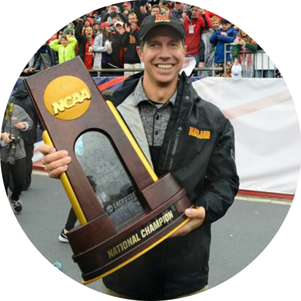 John Tillman, Head Coach of the University of Maryland, holding an NCAA "National Champion" trophy